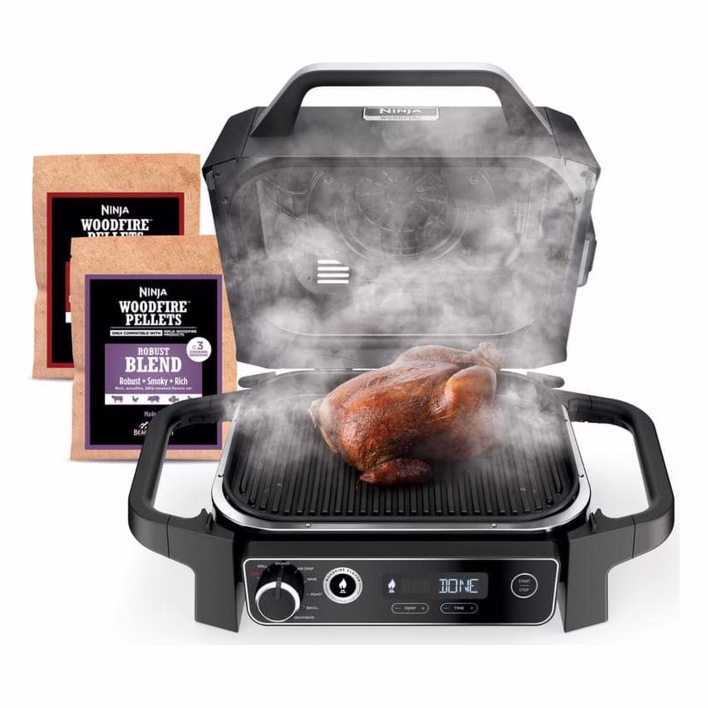 Ninja Woodfire Outdoor Grill OG701C lid open smoking a whole chicken with Woodfire pellets