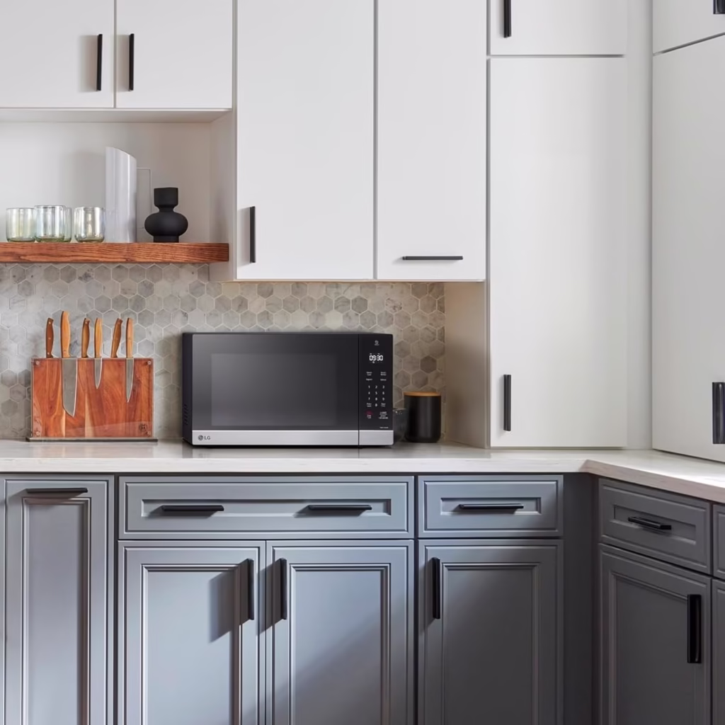 LG MSER1590C stainless steel countertop microwave on a kitchen counter beside a knife block