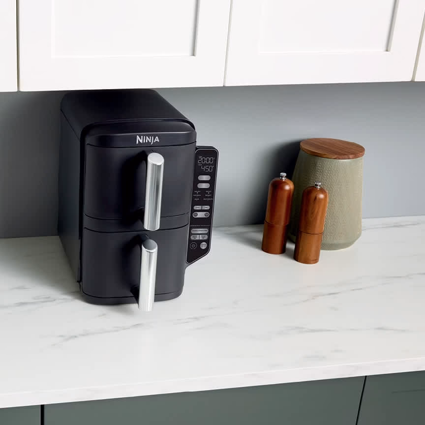 Ninja DoubleStack 2-Basket Air Fryer SL201C on a kitchen counter, showing the slim stacked footprint under standard upper cabinets