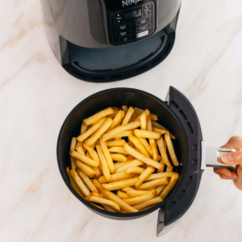 Ninja AF101C air fryer basket seen from above with a full load of French fries