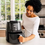 Ninja AF101C air fryer on a kitchen counter with the basket slid out