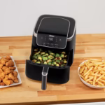 Ninja AF141C air fryer on a kitchen counter with roasted Brussels sprouts in the basket