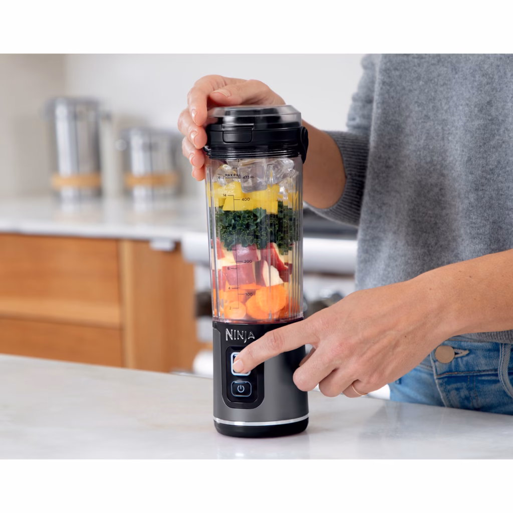 Pressing the separate power and blend buttons on the Ninja Blast BC151BKC blender