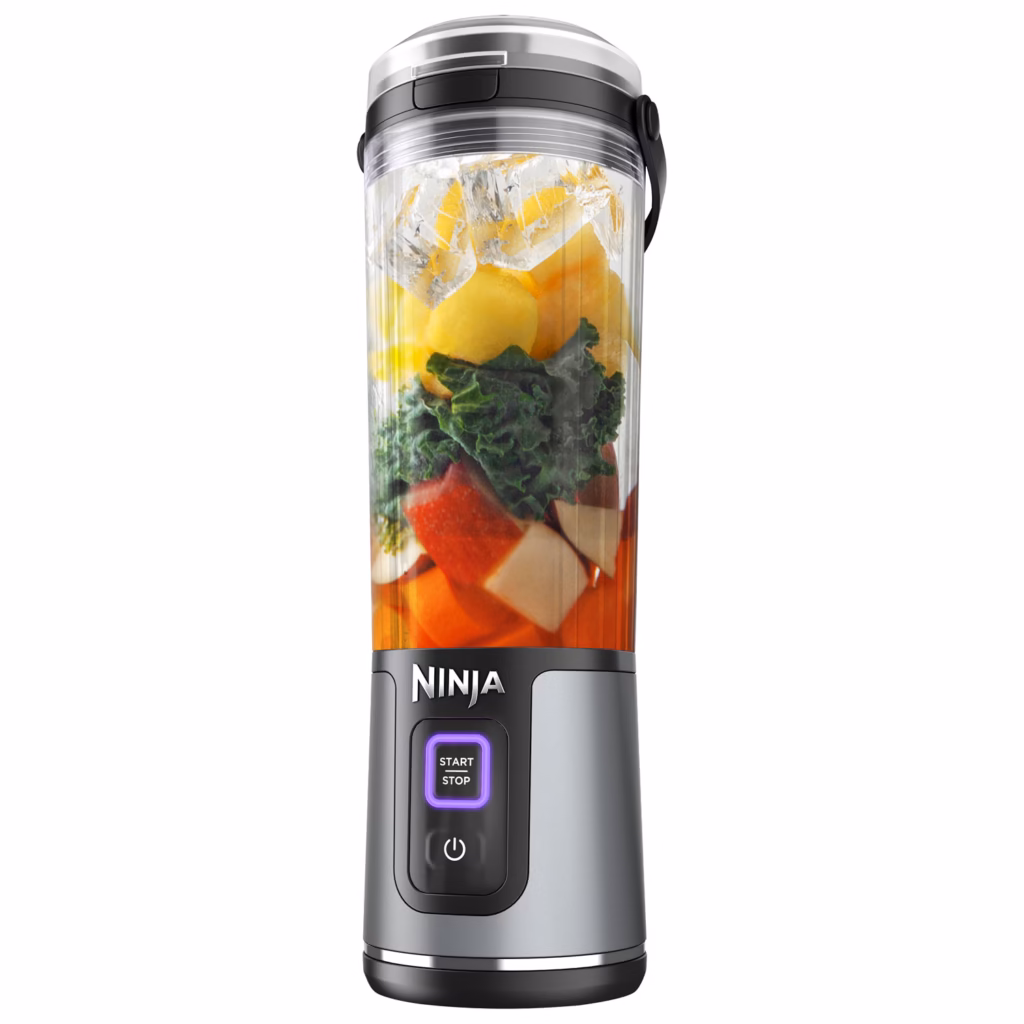 Ninja Blast BC151BKC blender vessel filled with layered fruit and greens