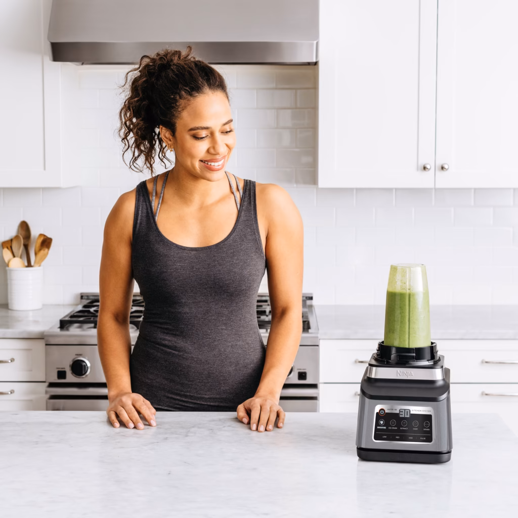 Ninja BN801BBYC kitchen system blending a green smoothie on a counter