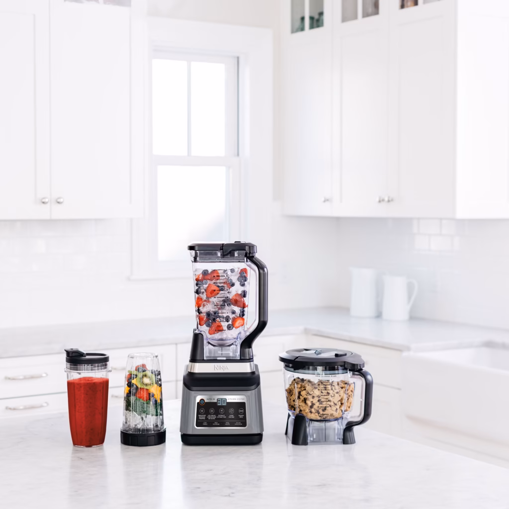Ninja BN801BBYC blender pitcher, processor bowl and to-go cup on a kitchen counter