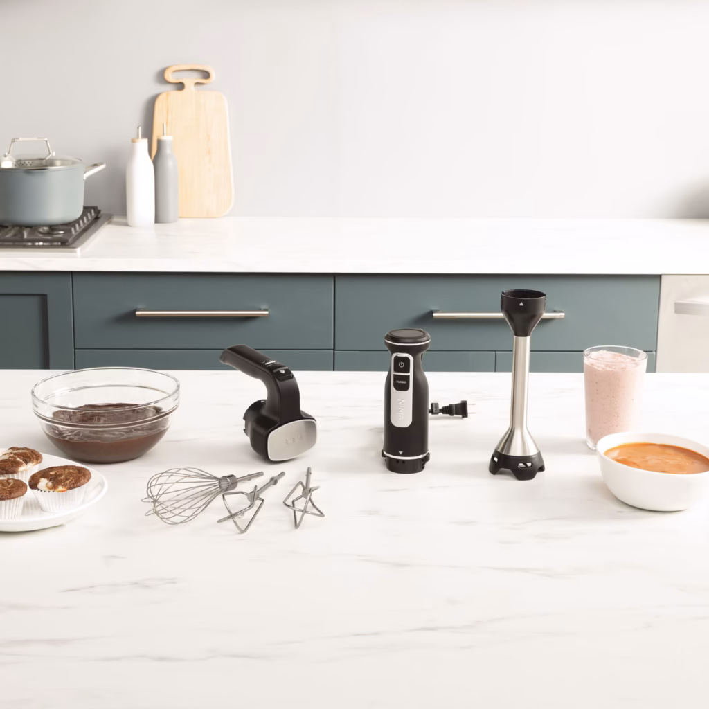 Ninja CI100C power mixer system with attachments laid out on a kitchen counter