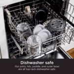 CREAMi pints, lids, paddle and outer bowl loaded on the top rack of a dishwasher