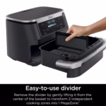 Ninja DZ071C removable divider being lifted from the centre of the air fryer basket