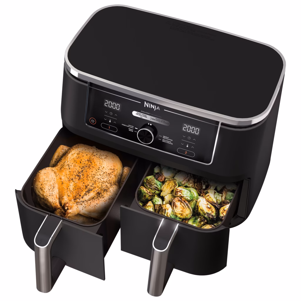 Ninja DZ300C dual zone air fryer with both baskets open holding a whole chicken and brussels sprouts