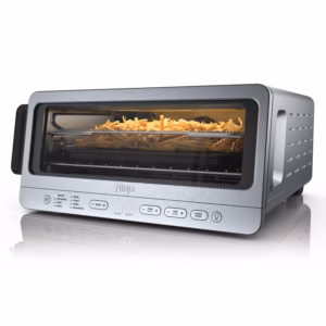 Ninja Flip Toaster Oven SP151C in stainless steel, front three quarter view with fries in the air fry basket