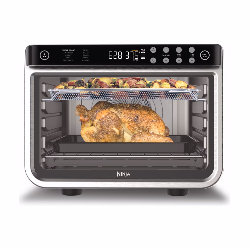 Ninja Foodi XL Pro Air Fry Oven DT201C in stainless steel with a whole roast chicken and a tray of vegetables cooking on two levels