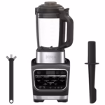 Ninja HB150C blender with its tamper and cleaning brush laid out beside the pitcher