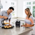 Ninja HB150C pouring hot blended queso dip from the glass pitcher onto a snack board
