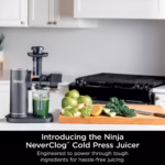Ninja NeverClog Cold Press Juicer JC151C on a kitchen counter with fresh produce