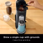Ninja PB040C brewing into a travel mug with ground coffee being measured into the brew basket