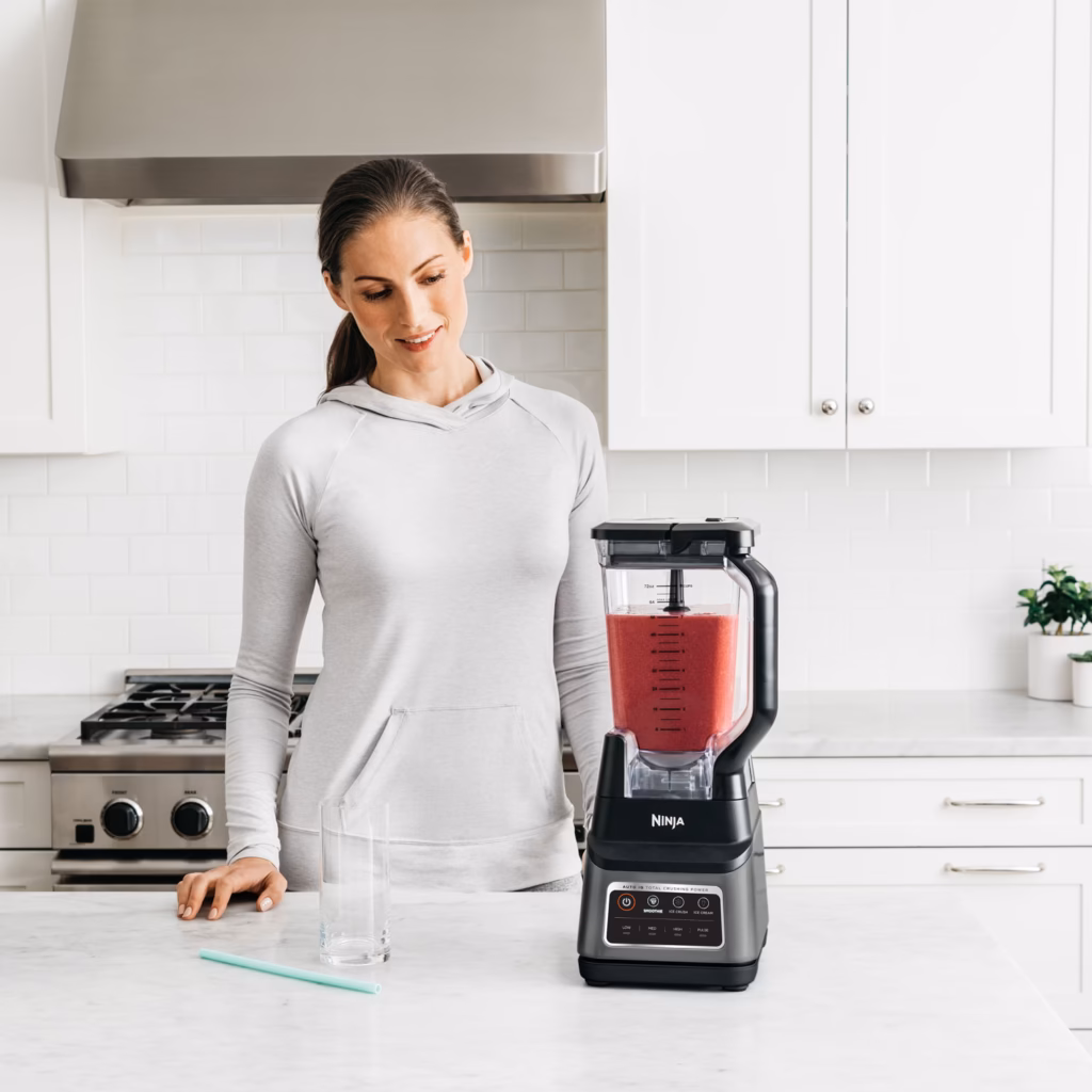 Ninja BN701C Professional Plus blender with a blended red smoothie in the 72 oz pitcher