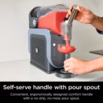 Ninja SLUSHi self-serve comfort handle and anti-drip pour spout filling a glass