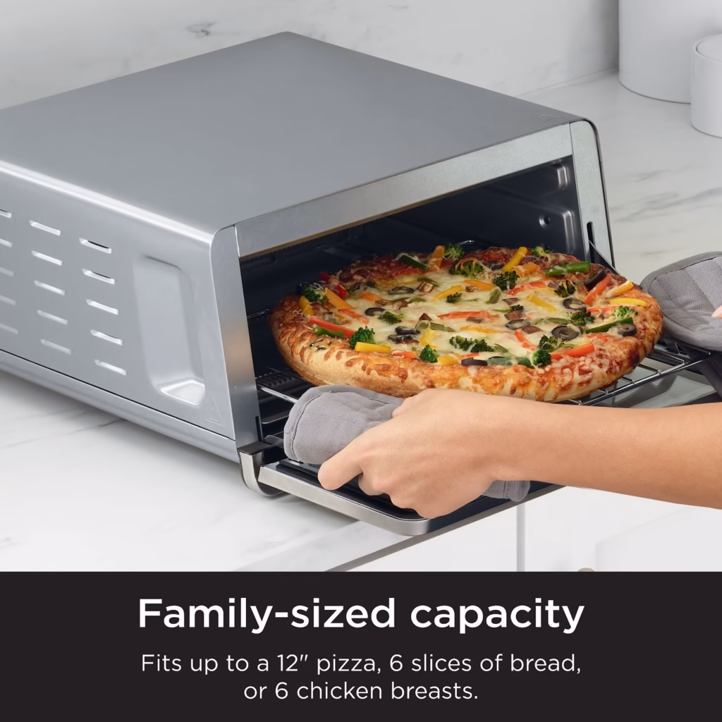 Ninja SP151C with a 12 inch pizza being lifted out of the oven on the wire rack