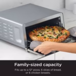 Ninja SP151C with a 12 inch pizza being lifted out of the oven on the wire rack