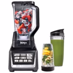 Nutri Ninja Duo BL641C blender with berry-filled 72 oz pitcher beside a 24 oz green smoothie cup
