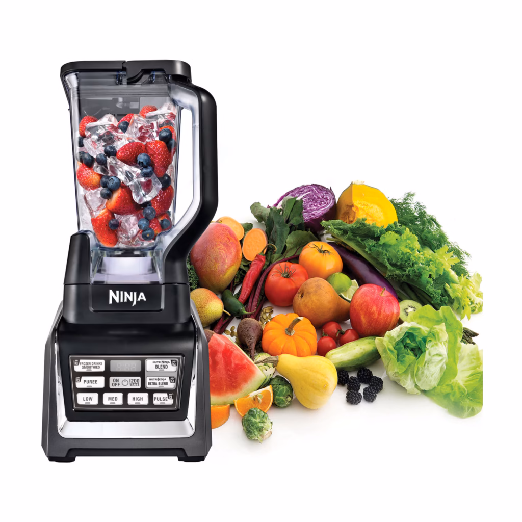 Nutri Ninja Duo BL641C blender pitcher of berries beside fresh fruit and vegetables