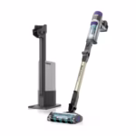 Shark PowerDetect IP3251C cordless stick vacuum leaning beside its Auto-Empty dock, three quarter view