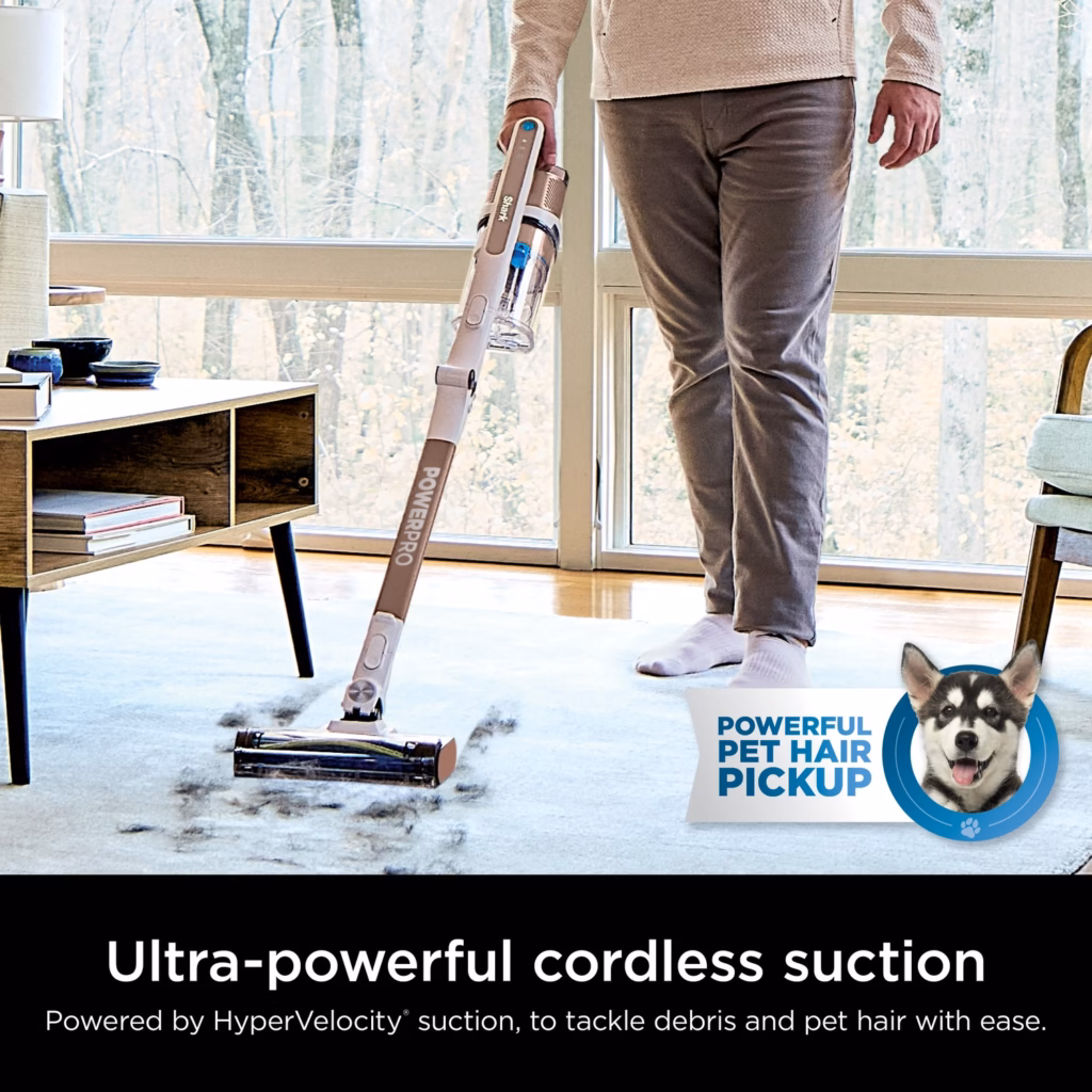 Shark PowerPro Flex IZ380HC cordless stick vacuum lifting pet hair from an area rug beside a sunlit window