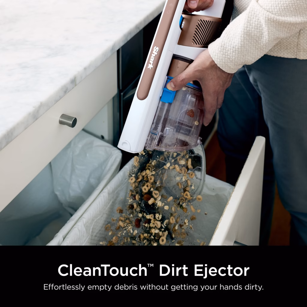 Shark PowerPro Flex IZ380HC hand vacuum emptying its bagless dust cup into a bin with the CleanTouch Dirt Ejector