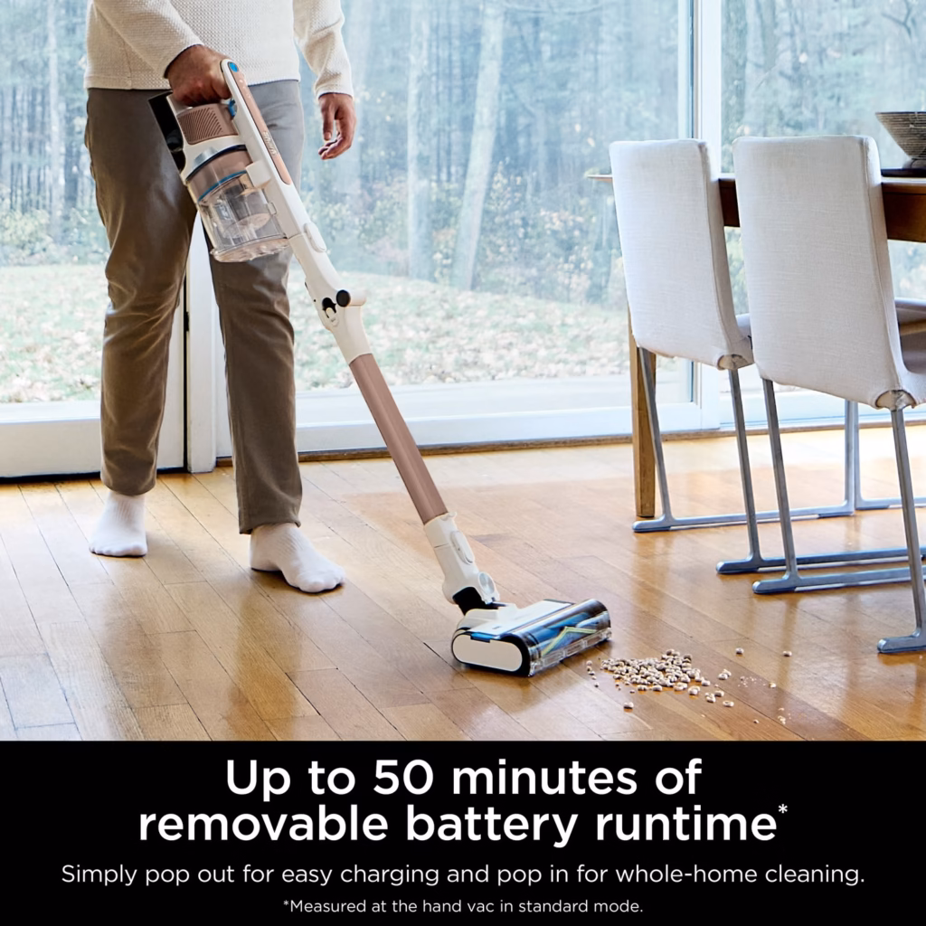 Shark PowerPro Flex IZ380HC cordless stick vacuum in use on hardwood beside a dining table